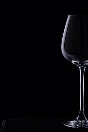 Elegant glass of wine standing isolated on the dark backgroundの写真素材