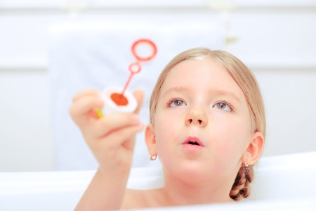 Happy days of childhood. Cropped image of a cute little girl taking a bath and playing with soap...