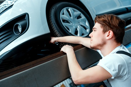 Just check one more thing. Side view portrait of a concentrated handsome mechanic in uniform...