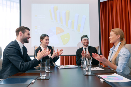 Successful presentation. Participants of the business meeting applaud each other delighted with the results of the meetingの写真素材