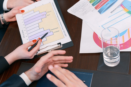 Analytical information. Closeup of the charts and diagrams held in hands by business managers in...