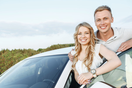 Sweet couple. Portrait of a handsome young man and beautiful blond girlfriend with curvy hair...