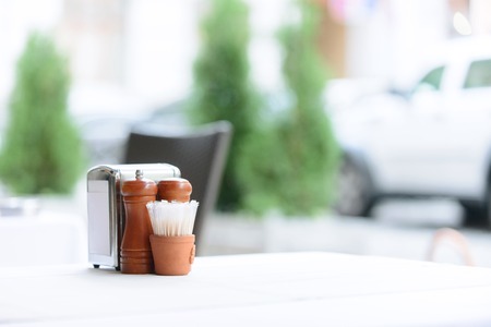 Ready for guests. Close up of napkins and saltwort standing on the table of the cafeの写真素材
