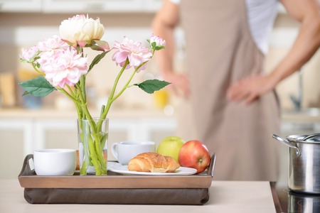 Exquisite breakfast. Wooden tray with fine healthy breakfast rests on the table.の写真素材