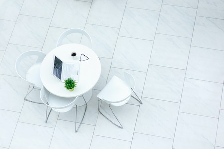 Ordinary day. Top view of table with chairs standing in the cafeの写真素材