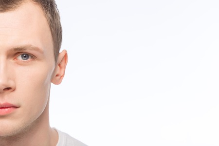 Looking serious. Young handsome man is posing on the camera