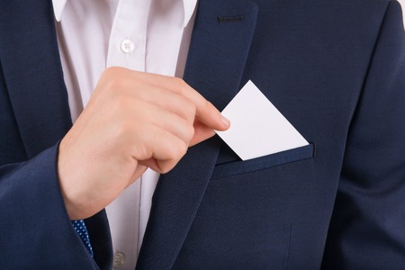 Card for advertising. Male hand taking out business card from breast pocket.の写真素材
