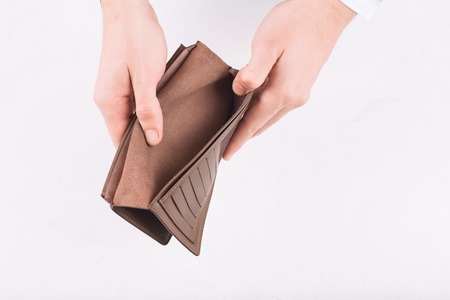 No money. Male hands demonstrating open wallet with nothing in it.