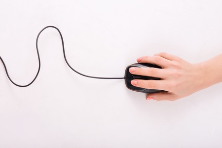 Computer mouse. Female hand in process of using PC mouse.