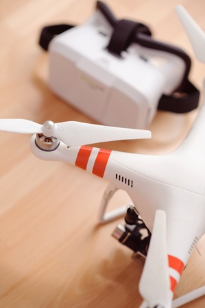 Word is changing. Close up of wireless flying and virtual reality devices  lying on the table