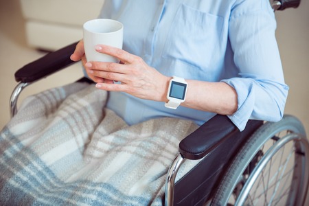 Tea relax. Cropped image of old woman in wheelchair holding cup of teaの写真素材