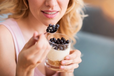 My week point. Cropped image of smiling young women eating sweat desertの写真素材