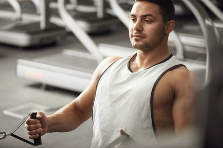Concentrated on a physical activity. Good looking confident hard working sportsman doing a physical...
