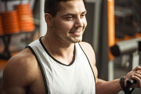 Positive attitude. Optimistic good looking brunette man smiling and enjoying a physical activity...