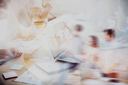 Time to brainstorm. Blurred photo with film effect of business crew having professional meeting in office on worldwide background.の写真素材