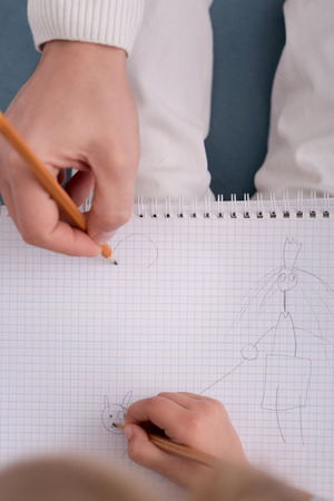 Pencil drawing. Close up of a picture being drawn with the pencil by the hand of a young creative talented childの写真素材