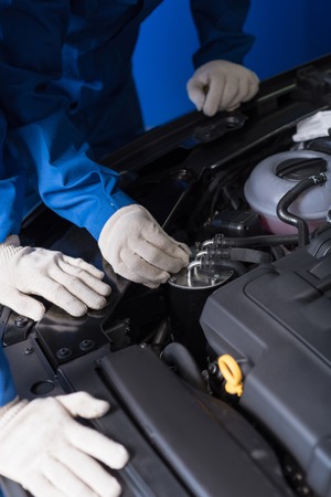 Close up of car engine while professional mechanics checking and repairing itの写真素材