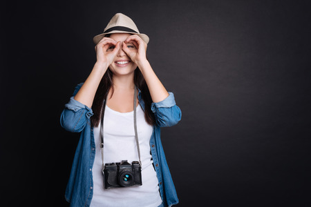 Delighted smiling woman looking at yo and getting ready for holidays while sharing positive emotionsの写真素材