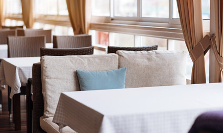 Classic modern neoteric interior of the cafe full of furniture and represented in the minimal designの写真素材