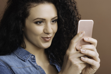 Attractive brunette using her mobile phoneの写真素材