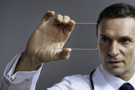 Concentrated doctor holding a glassの写真素材