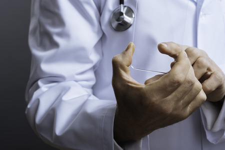 Close up of professional doctor holding special glass equipmentの写真素材