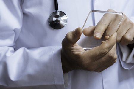 Close up of professional doctor touching medical glassの写真素材