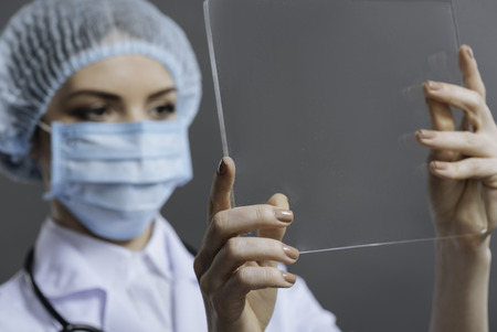Beautiful woman using medical glassの写真素材