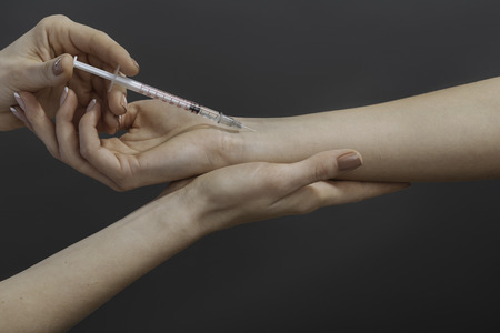 Close up of doctors hands making an injectionの写真素材