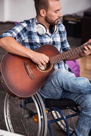 Focused musician playing guitarの写真素材