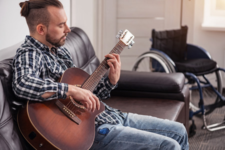 Handsome handicapped man enjoying his hobby