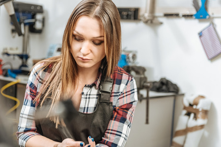Serious young worker sitting in the repair shopの写真素材