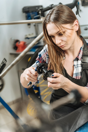 Peaceful young master fixing the detail in the repair shopの写真素材