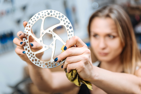 Enthusiastic female technician holding the big cogwheelの写真素材
