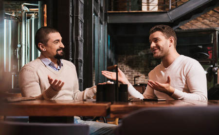 Delighted handsome men looking at each otherの写真素材