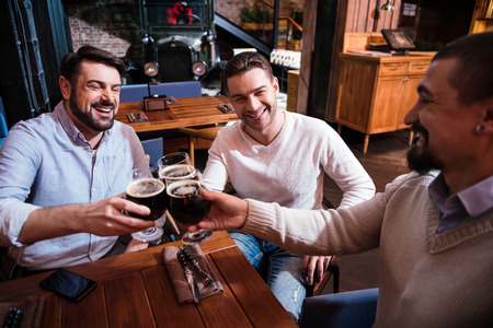 Happy positive man enjoying their drinkの写真素材