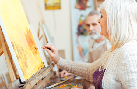 Female artist painting in classの写真素材