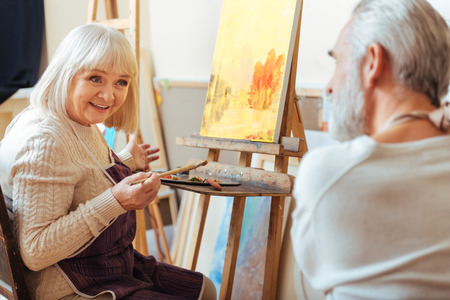 Male and female artists talking to each other.の写真素材