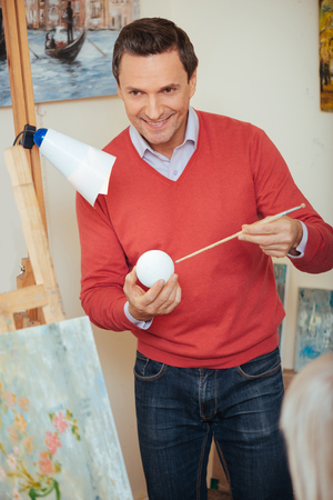 Ambitious artist teaching people in painting studio.の写真素材