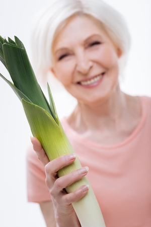 Close up of leek being situated in female handの写真素材