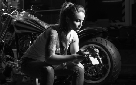 Serious girl holding special tool in both handsの写真素材