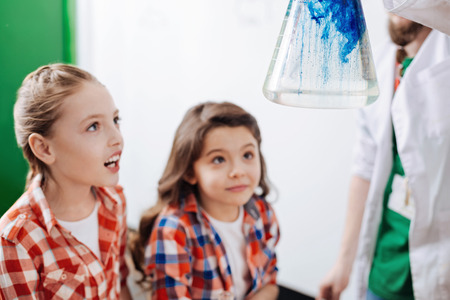Cute exited girls looking at the chemical reactionの写真素材