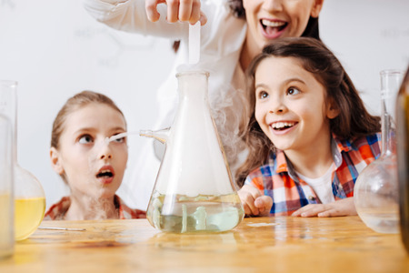 Happy exited girls looking at the flask