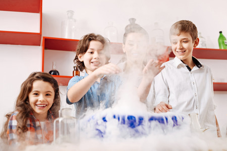 Cheerful positive children enjoying their time in the labの写真素材