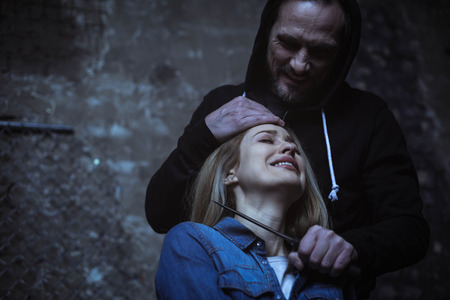 Raging violent abductor scaring his victimの写真素材