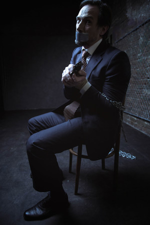 Threatened kidnapped man hoping to escapeの写真素材