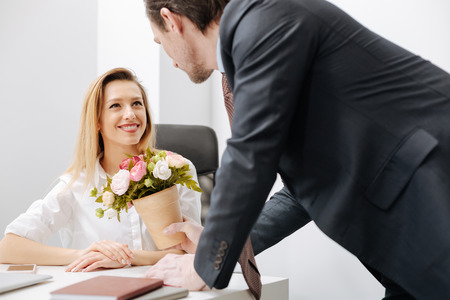 Charismatic employer giving present to the employee in the officeの写真素材