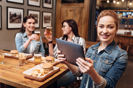 Cute girl showing her tabletの写真素材