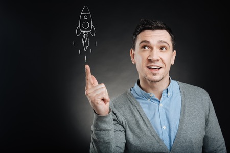 Confused man launching a rocketの写真素材