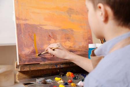 Gifted boy painting in the art studioの写真素材